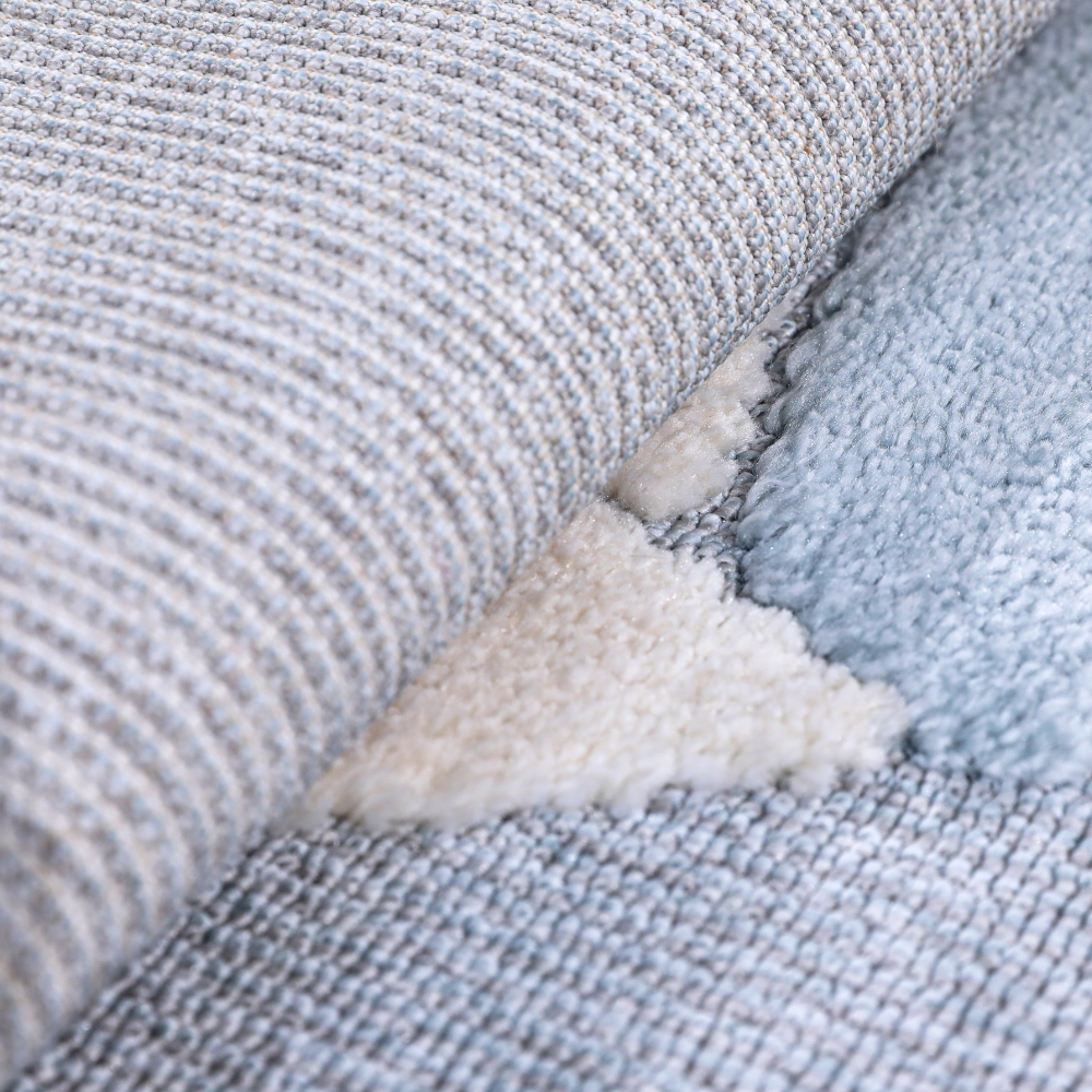 Close-up of kids woven rug with soft blue and cream cloud design for playful decor.