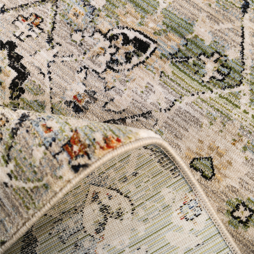 Wren geometric textured rug featuring green and beige floral patterns