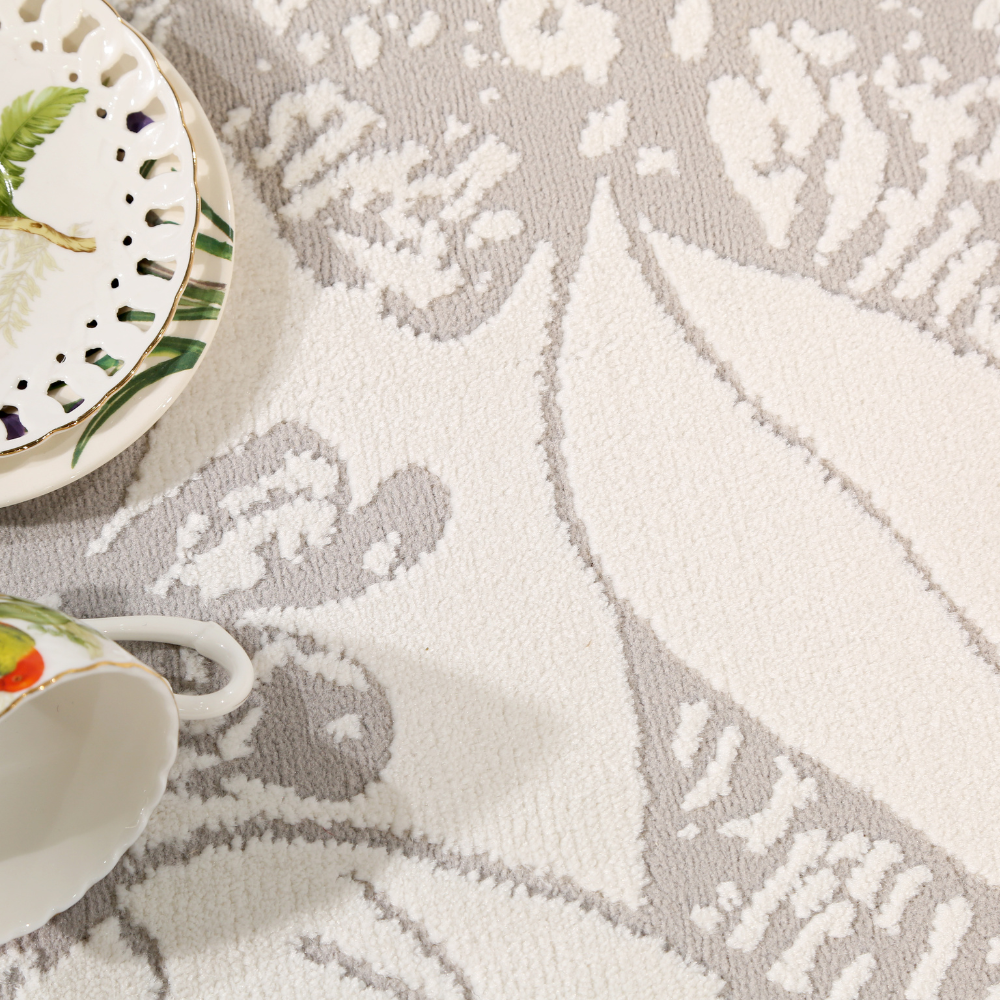 Celeste Flower Textured Rug with grey floral patterns and tableware
