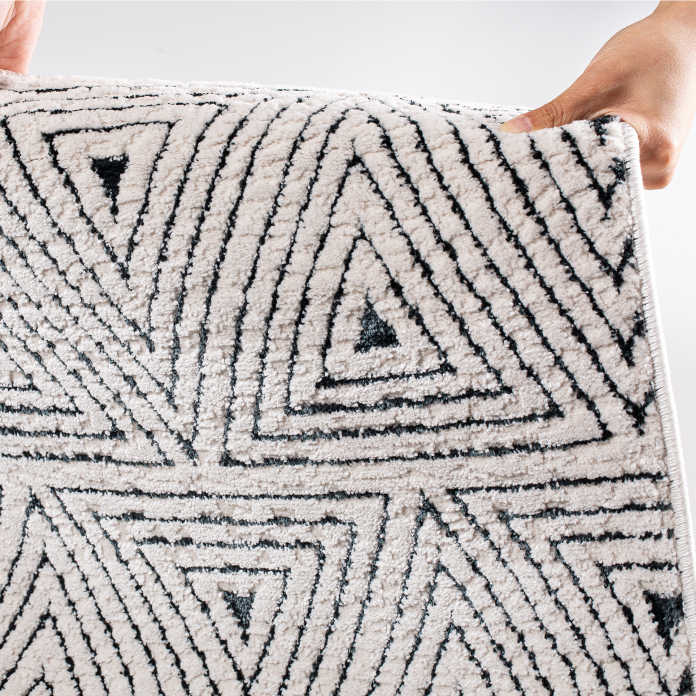 Zephyr Triangle Textured Rug with soft geometric design for stylish interiors.