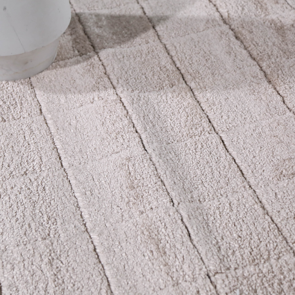 Close-up of beige checkered textured rug for modern home interiors