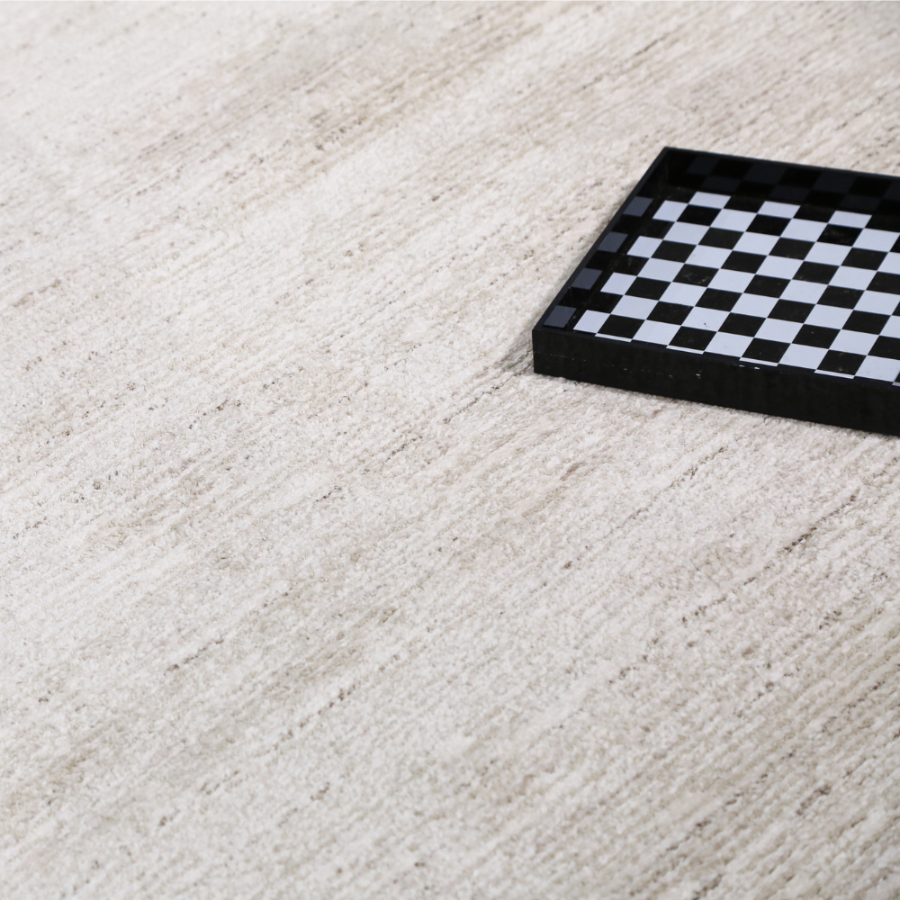 Romulus textured rug in light color with checkerboard tray, ideal for modern interiors.